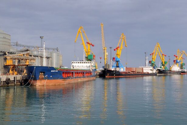 A port terminal in Kazakhstan with cargo ships and large cranes facilitating oil exports via the Caspian Sea. The infrastructure highlights Kazakhstan’s alternative oil export routes.